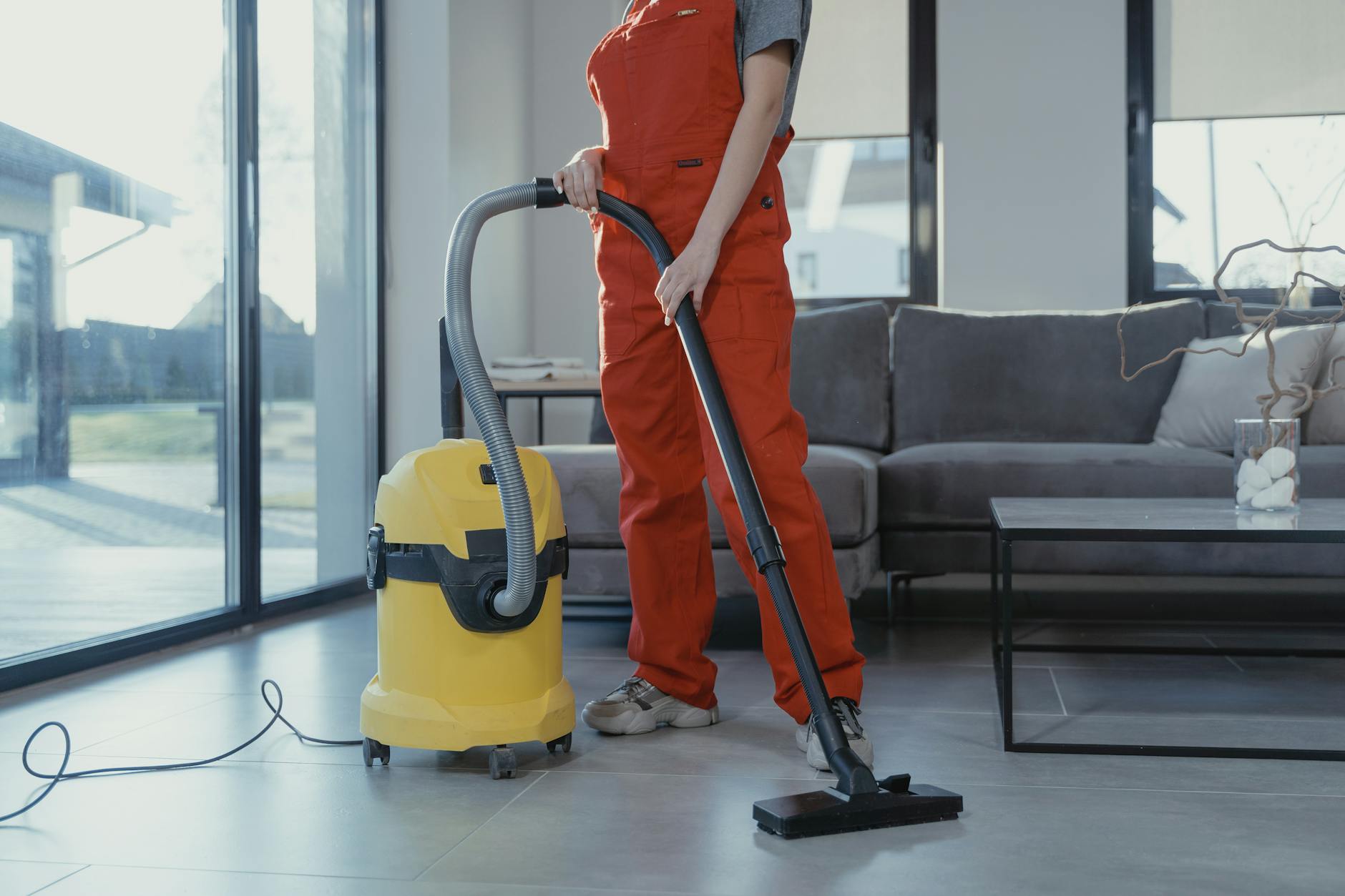 person vacuuming the floor